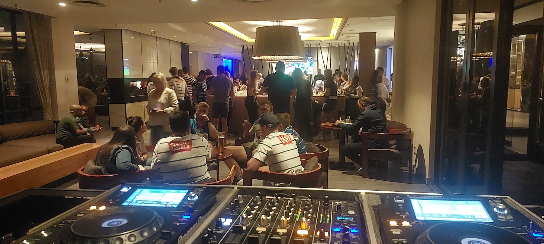 View from the Entertainworx DJ booth across a busy celebration