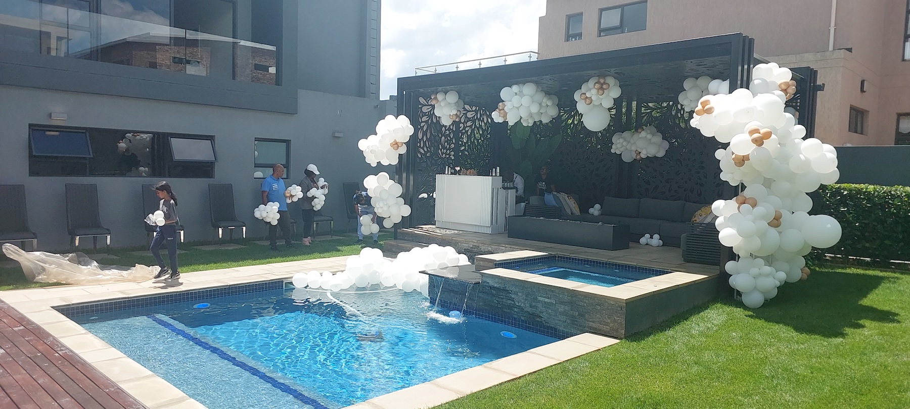 Elegant white outdoor event setup beside a pool