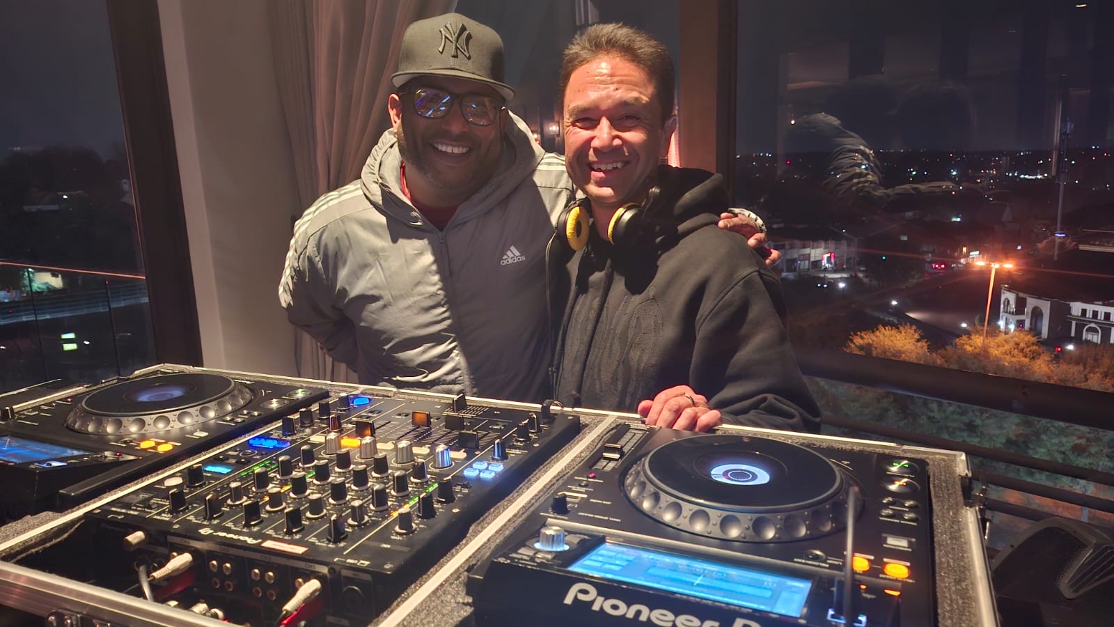 Entertainworx DJs behind Pioneer equipment at a rooftop venue