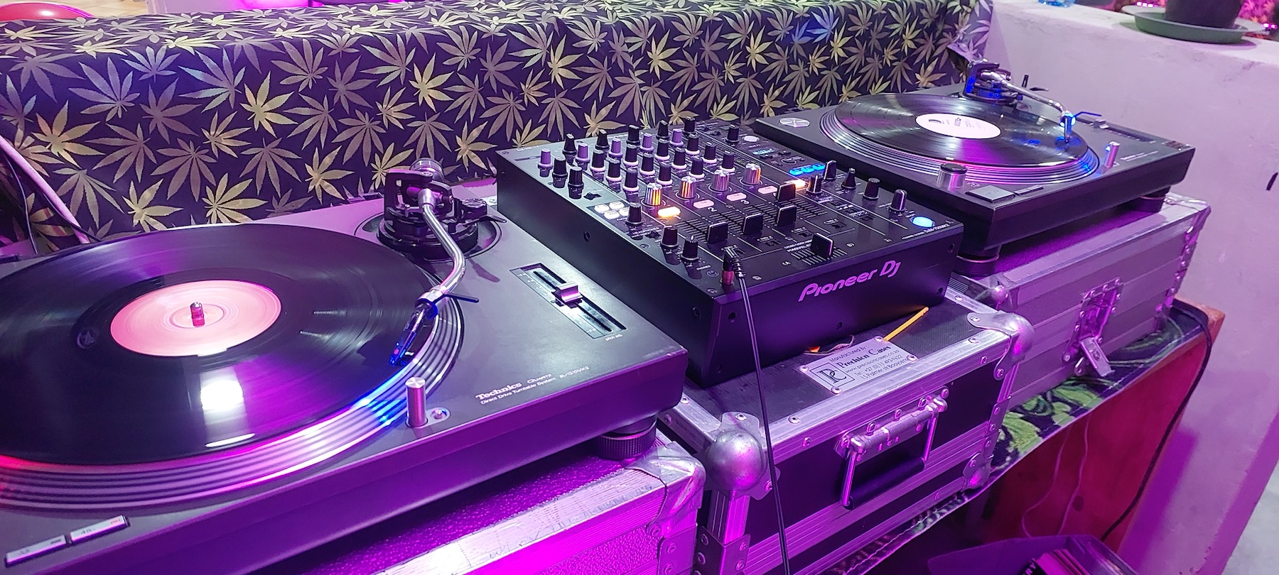 Professional Pioneer mixer and vinyl turntables under event lighting