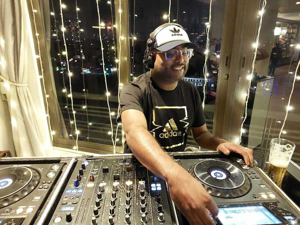 Entertainworx DJ performing behind professional decks